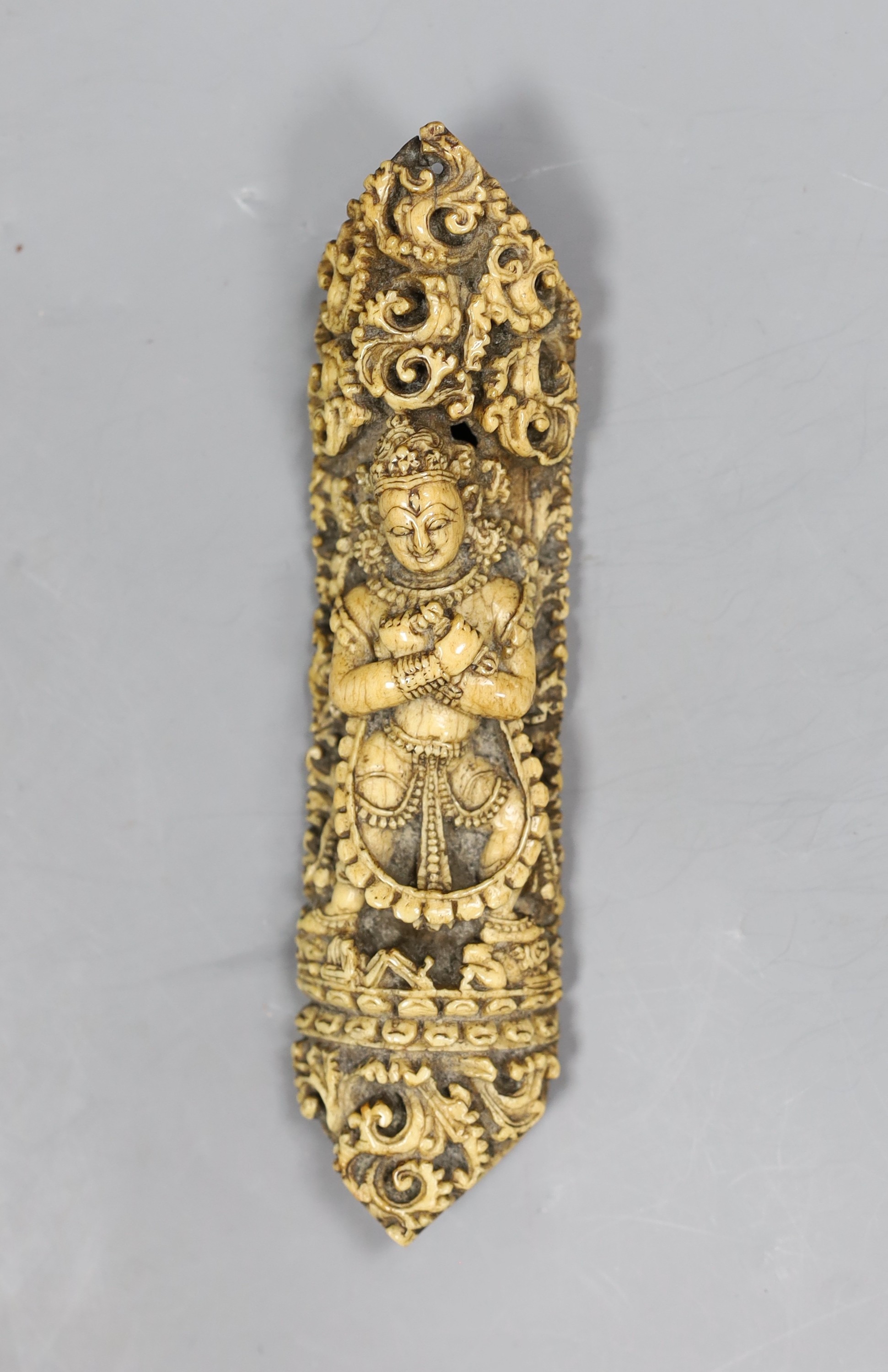 A 19th century Burmese bone carving of a Buddhist deity, 15cm tall